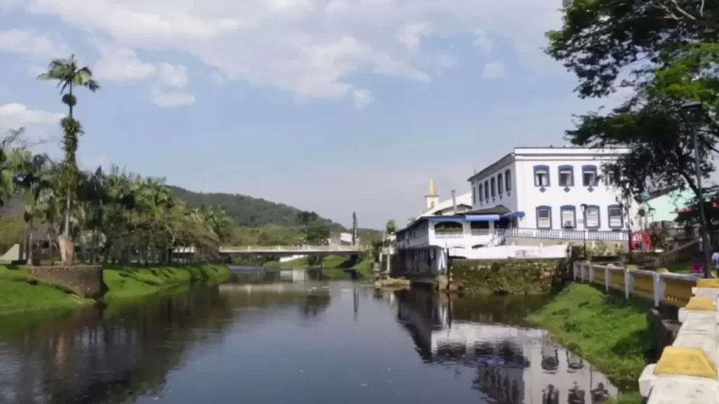Vista do centro histórico de Morretes com rio Nhundiaquara ao lado de casarões coloniais e vegetação tropical.